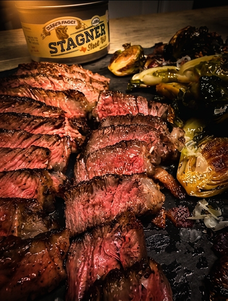 Stagner Steak Rub tin dramatic golden spotlight lighting dark moody background premium Texas BBQ seasoning product photo